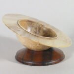 Russ Babbitt - Saturn Ring in Hollywood Juniper on base - 1" H x 3 3/4" Dia. the ring is freely rotating.