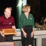 Out going president Al Geller holding huge block of cocobolo presented to him by incoming president Martha