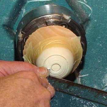 Sphere remounted in wooden jam chuck secured with tape; details being added