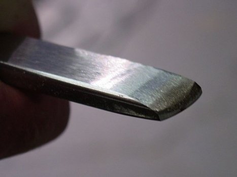 Close-up of bottom of scraper with double bevel